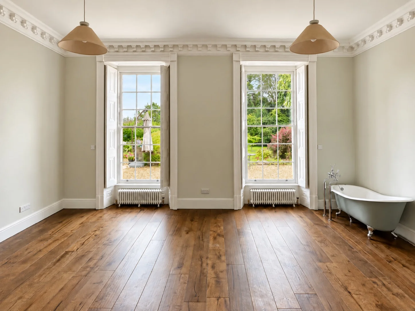 Restored listed Georgian room near Keynsham with two sash windows, traditional cornicing, timber flooring and freestanding bath
